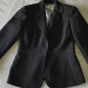 Woman’s Tahari Blazer and pants.